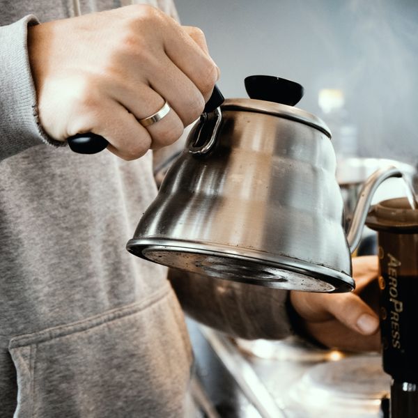 pouring water into an aeropress brewer